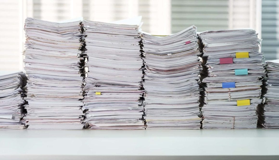 Papers piles, document stacked on working desk table at office r