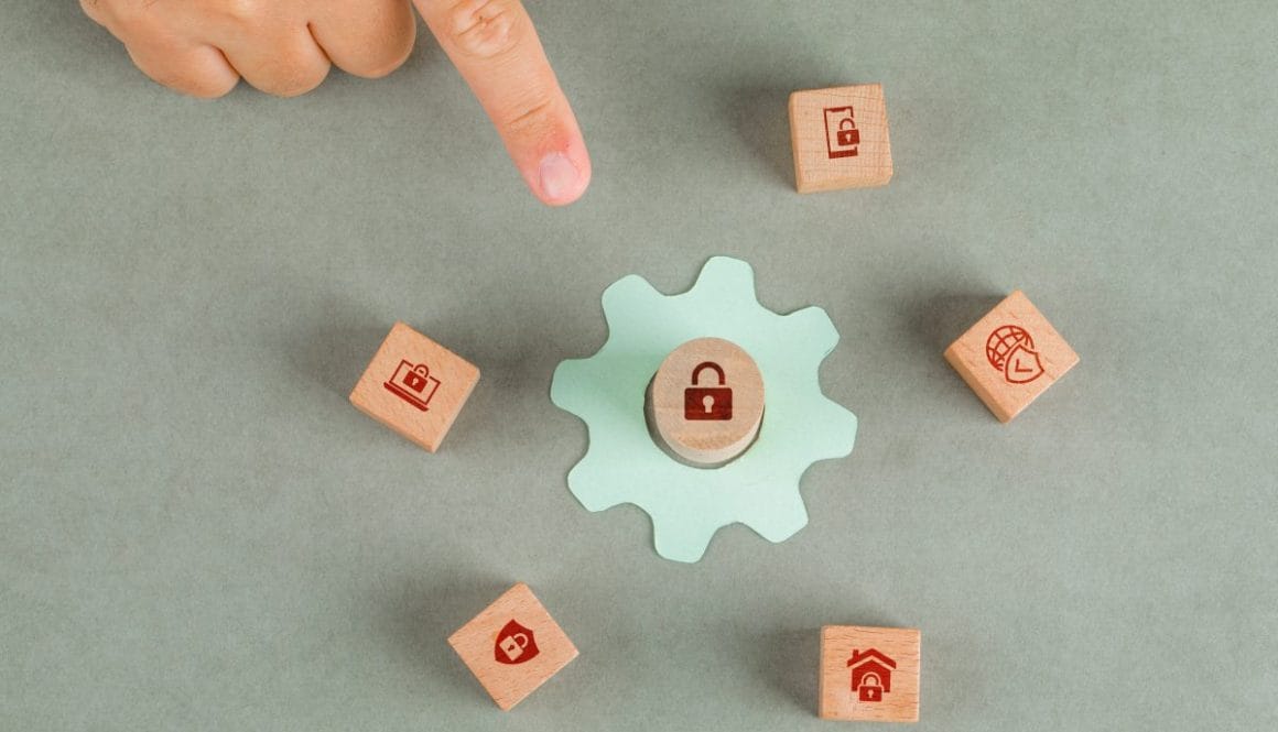 Conceptual of data privacy man hand pointing. with wooden blocks, paper settings icon on sage color background flat lay. horizontal image